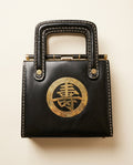 Black Structured Box Handbag with Brass Kanji Medallion and Gold Whipstitching - photo 1